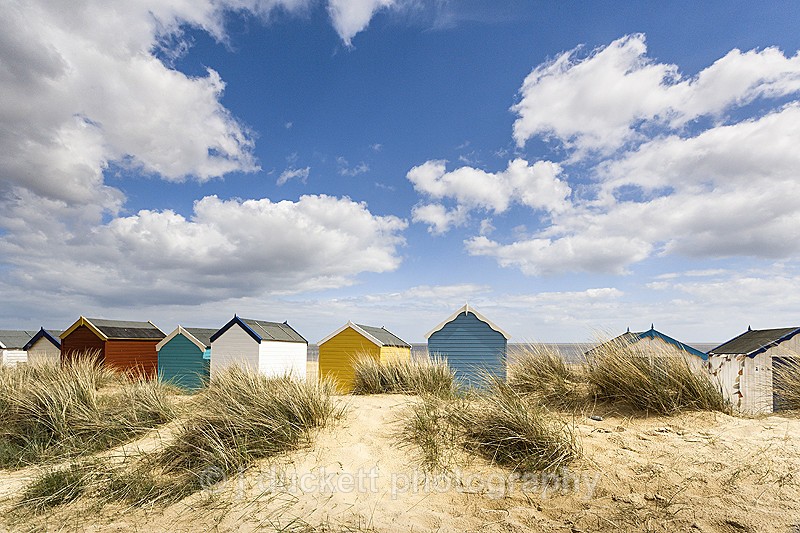 Suffolk Coast landscape photography of beach huts on the beach at Southwold