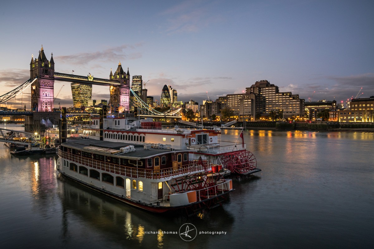 Tower Bridge at night from the south bank looking across the River Thames towards the city