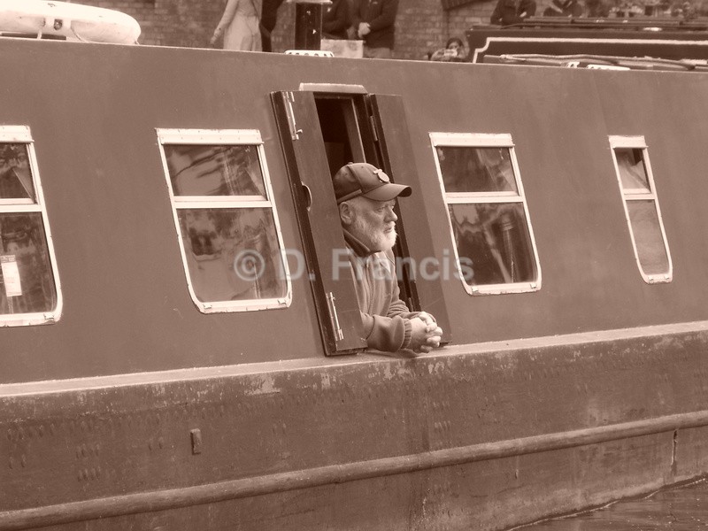 Man at barge window (sepia) - Little Venice Cavalcade