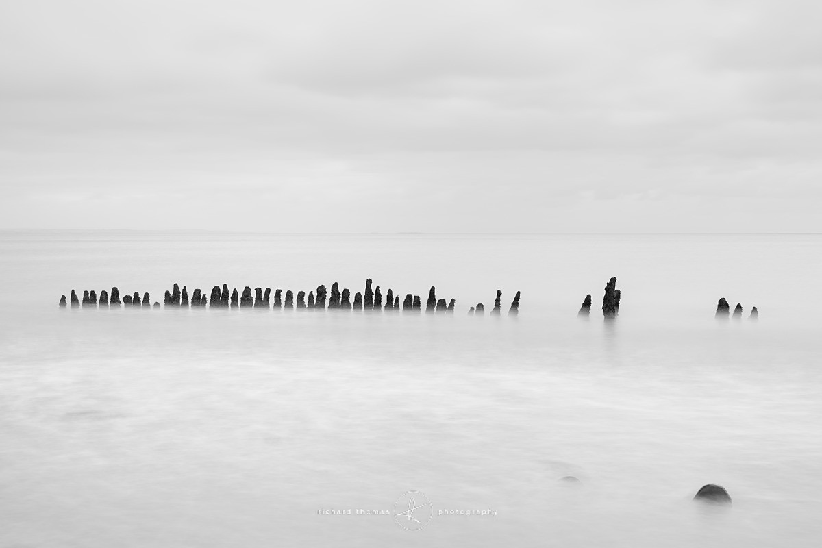 Groynes at Dunster beach in Somerset Long exposure black and white photograph