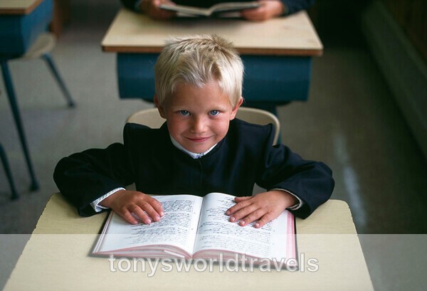 Young Hutterite Boy reading Bible, Alberta, Canada - World's Major Religions