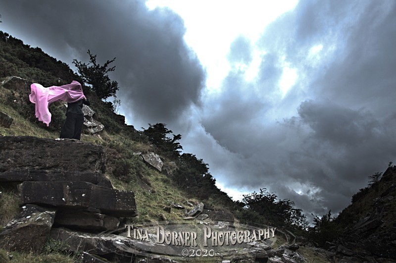 Storm clouds anf figure with pink veil. by Tina Dorner Photography, Forest of Dean and Wye Valley, Gloucestershire