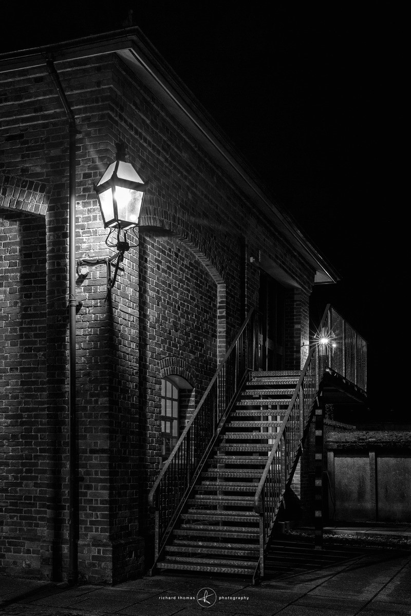 Metal staircase at the rear of Alresford station Watercress Line at night