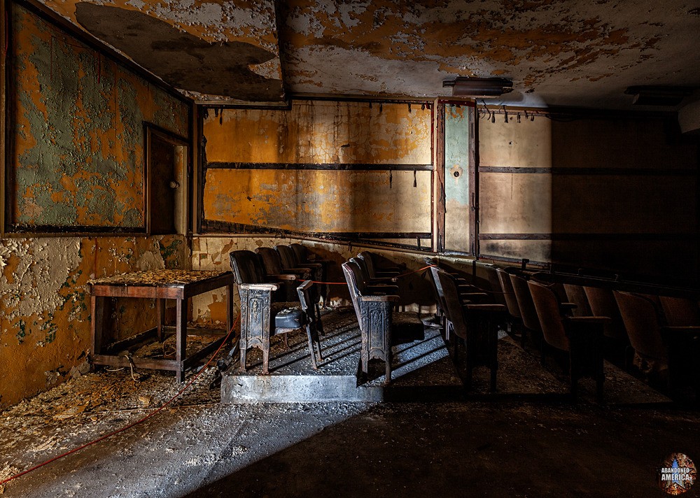 Rows of theater seats, half shrouded in darkness