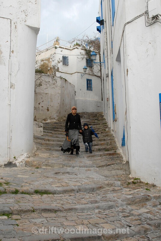 Sidi Bou Said woman on steps - Tunisia
