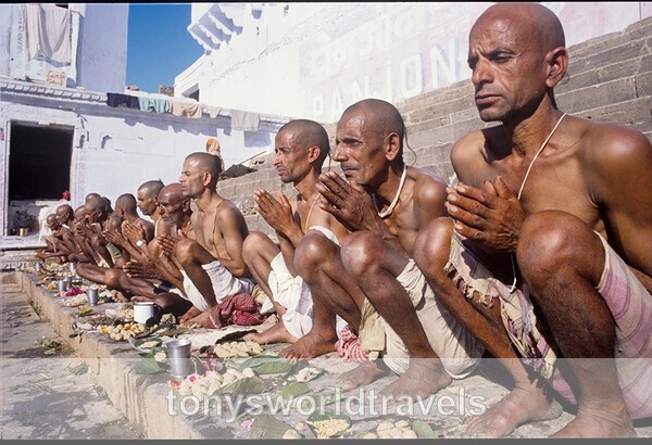 Men make puja at holy lake, India - World's Major Religions