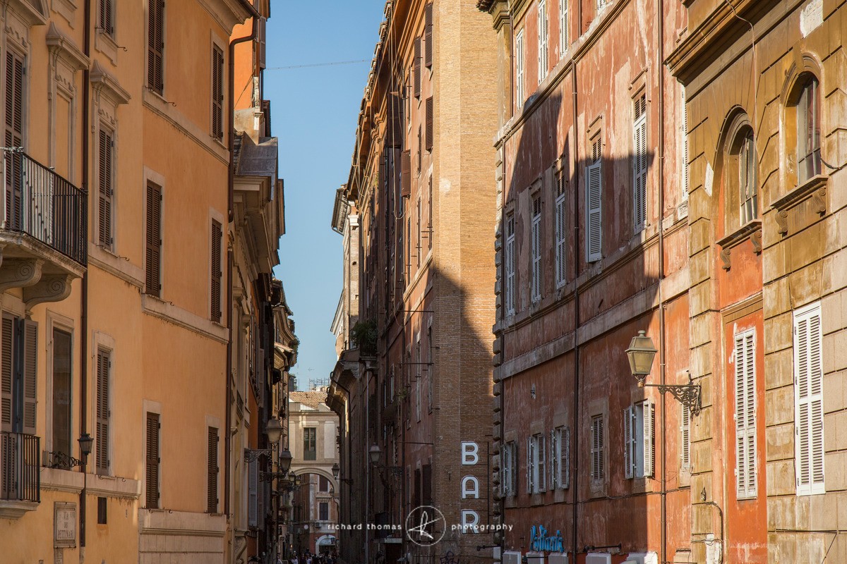 Bar and Buildings on a street in Rome, Italy. - Roman Walls