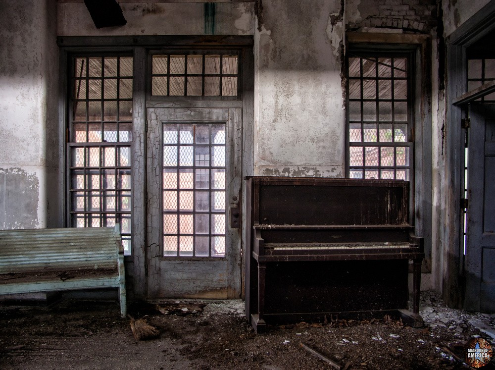 A bench sitting beneath a window in a day room at Taunton State Hospital