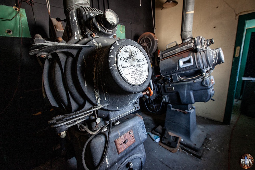 Closeup view of the rear of two antique movie projectors