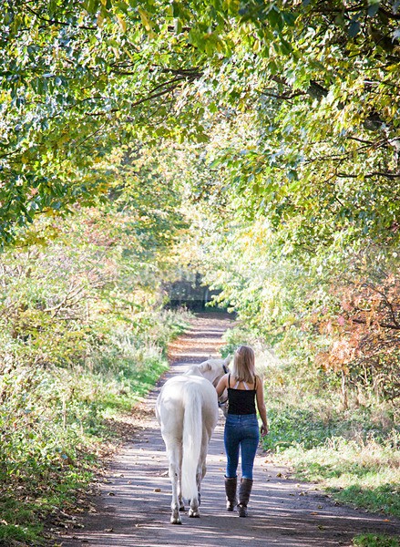 teenage girl walking away with grey pony - Equine Gallery Portfolio