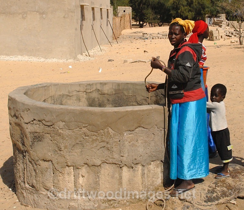 Senegal Fulani village woman at well - Senegal Fulani Village