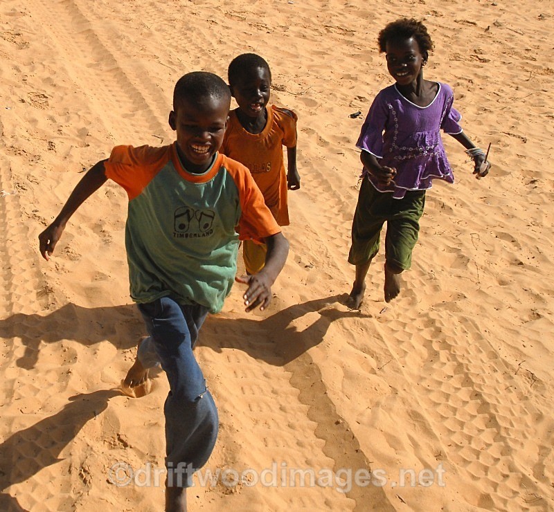 Senegal Fulani three village boys chasing truck  cropped - Senegal Fulani Village