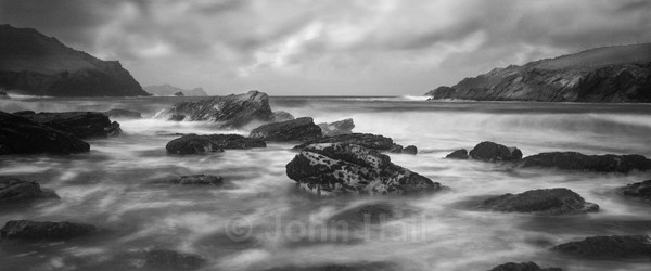 Fine Art Monochrome Of Waves Pounding The Rocky Shoreline At Clogher Beach, Co. Kerry, Ireland.