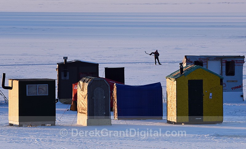 Icefishing Shacks and an Ice Hockey Player