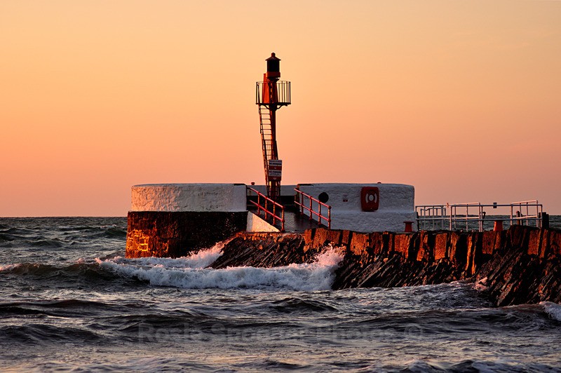 Banjo Pier just after sunrise bathed in golden light - Looe
