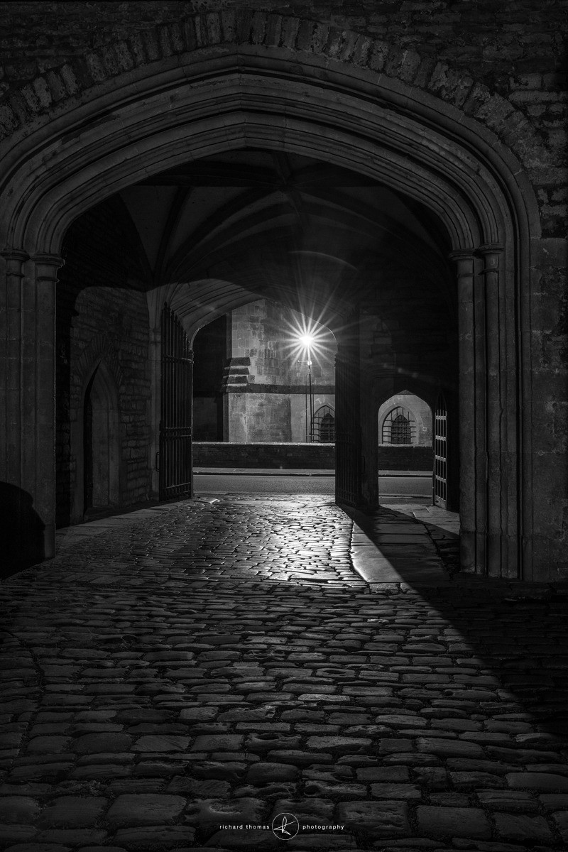 Entrance to Vicars Close opposite Wells Cathedral at night