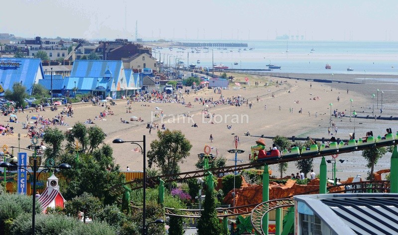 people on beach and on big dipper - Frank Doran