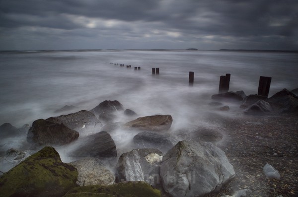 Rocks, Waves And Groynes At Youghal Beach, Co. Cork, Ireland.