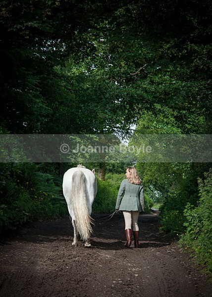 girl-and-pony-walking-htrough-trees - Equine Gallery Portfolio