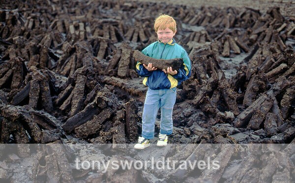 Young child holding a sod of turf, Co.Mayo, Ireland - Children