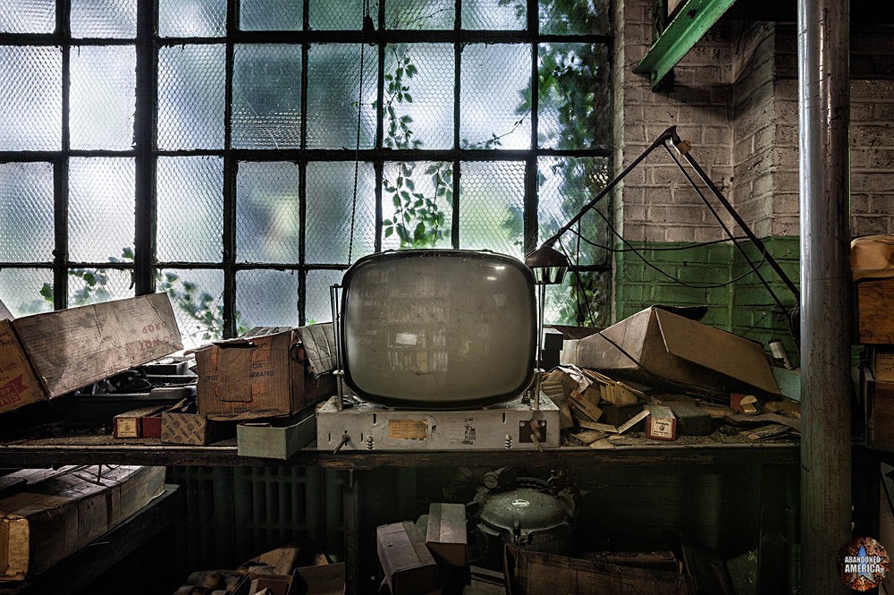 Photo of an abandoned, dusty workbench with an old CRT monitor
