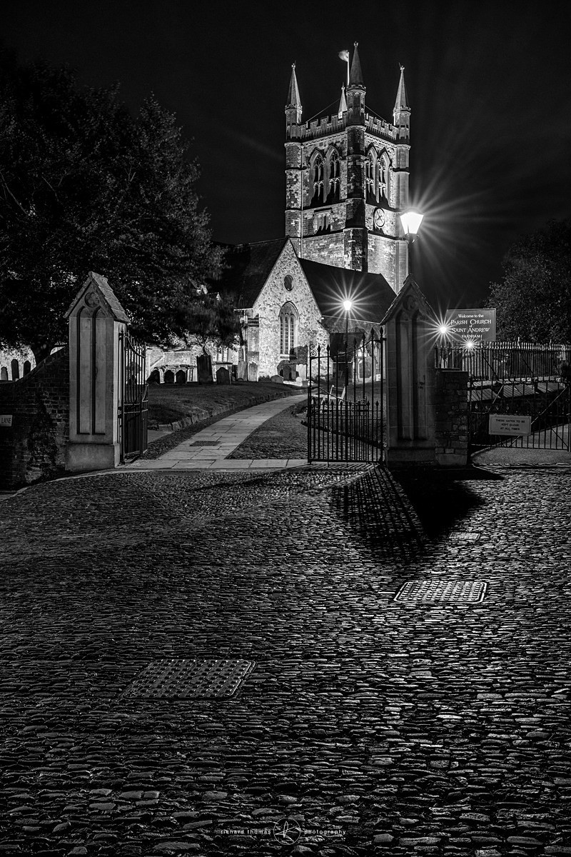 St Andrews church and cobbled street at night