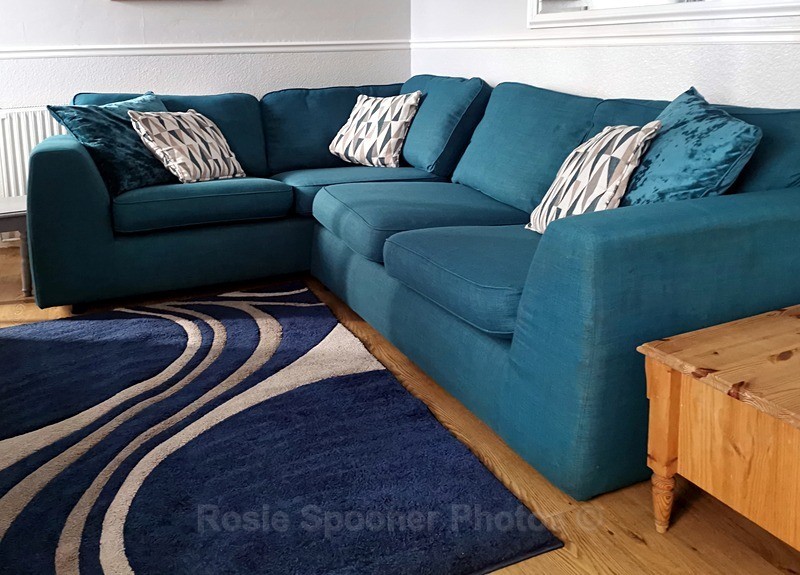 Corner settee in living area - ROSIE'S HOLIDAY LET DOLPHINS