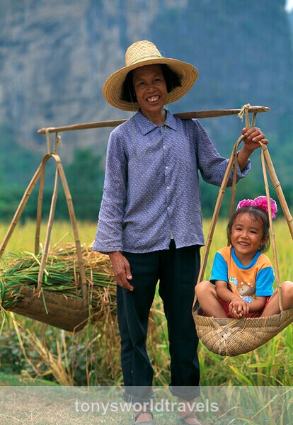 Woman with basket and child, Guilen, China - Smiling faces of the World