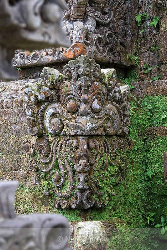 Stone carving covered with greenery, Penglipuran, Bali - Bali, Indonesia