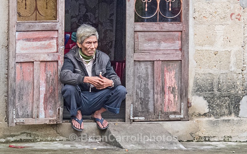 IMG_5169 Crouching man in doorway, Hue, Vietnam - Vietnam