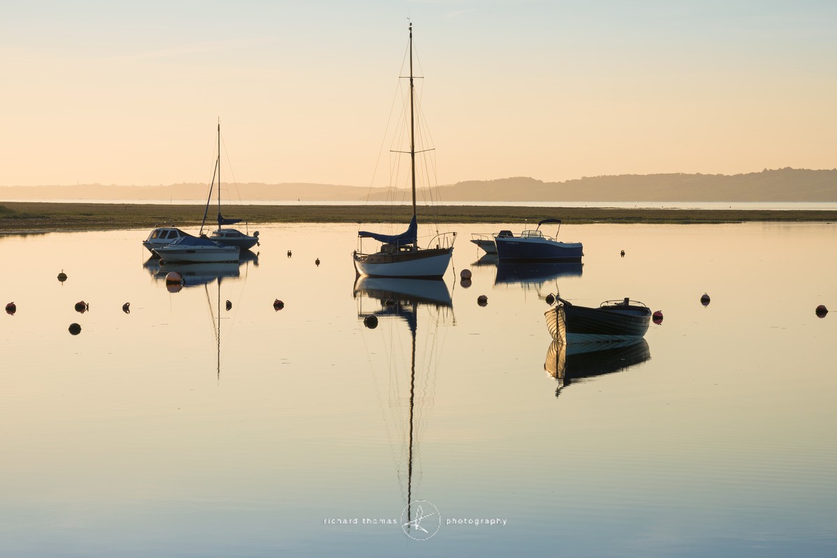 Yachts and boats in the salt marshes outside Keyhaven harbour near Lymington on a summer morning