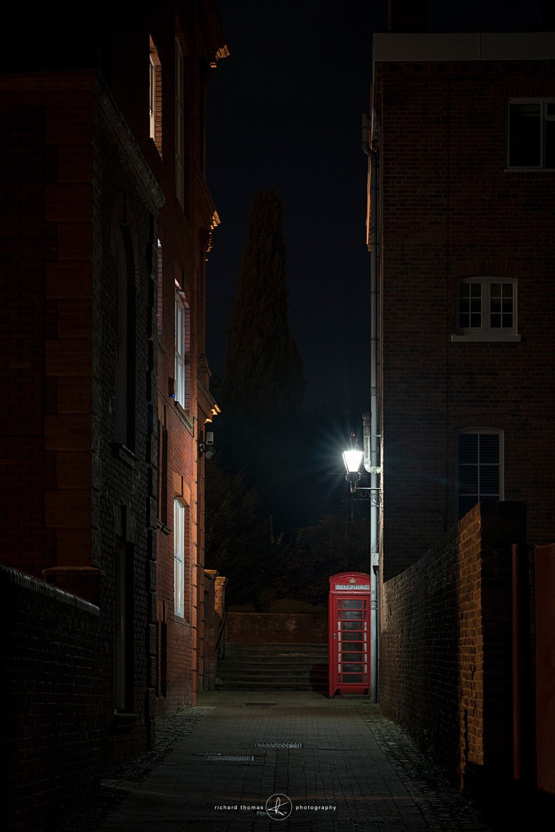A red telephone box at night in Winchester Hampshire