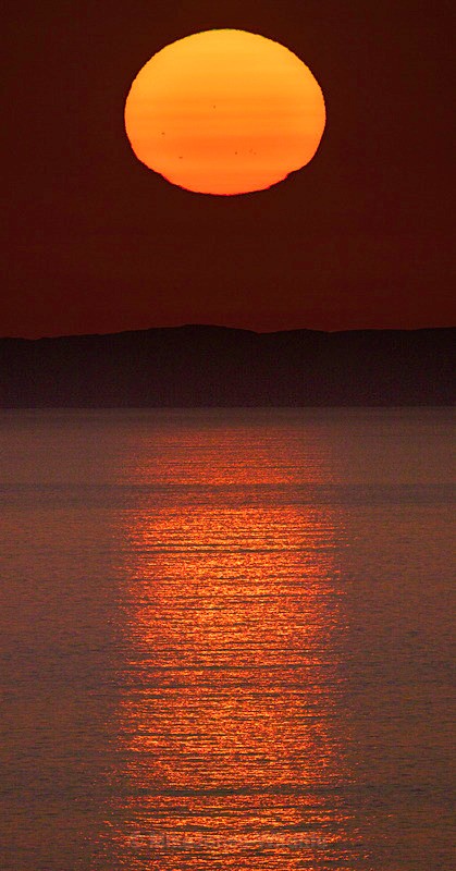 Sunset over the Isle of Coll< Inner Hebrides< Scotland - Sea Mist, Moonset and Sunset over the Hebrides seen from the Isle of Mull