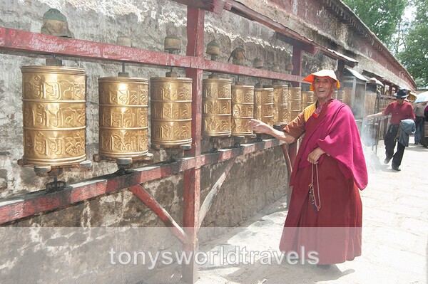 A smiling Buddhist monk  praying at  a temple, Lhasa,Tibet - World's Major Religions