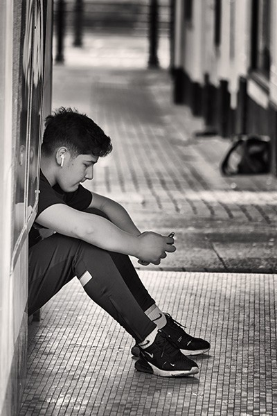 Young Man Relaxing On The Streets Of Galway City, Ireland.