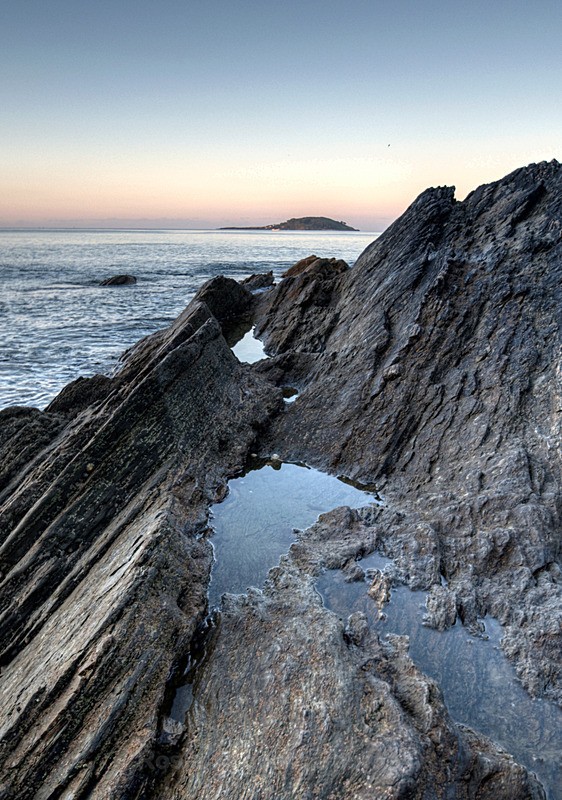 Rockpool view of Looe island in Cornwall