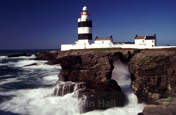 crashing seas at hook head lighthouse, co. wexford, ireland.